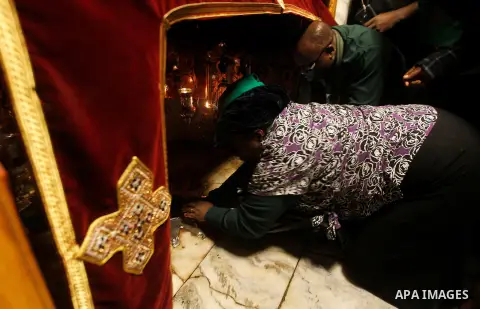 Visitors visit the holy star where Jesus Christ is believed to have been born inside the holy cave in the Church of Nativity during a Christmas tree lighting ceremony in the West Bank town of Bethlehem December 3, 2016....