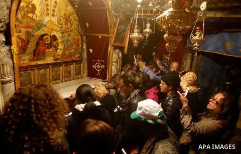 Visitors visit the holy star where Jesus Christ is believed to have been born inside the holy cave in the Church of Nativity during a Christmas tree lighting ceremony in the West Bank town of Bethlehem December 3, 2016....