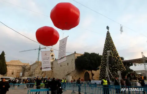 Palestinian Christians attend marking the lighting of a Christmas tree on December 3, 2016 at the Manger Square near the Church of the Nativity, revered as the site of Jesus Christ's birth, in the biblical West Bank town...