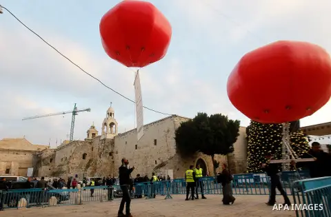 Palestinian Christians attend marking the lighting of a Christmas tree on December 3, 2016 at the Manger Square near the Church of the Nativity, revered as the site of Jesus Christ's birth, in the biblical West Bank town...
