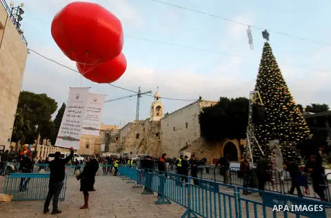 Palestinian Christians attend marking the lighting of a Christmas tree on December 3, 2016 at the Manger Square near the Church of the Nativity, revered as the site of Jesus Christ's birth, in the biblical West Bank town...
