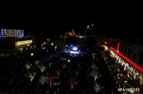 Palestinian Christians watch fireworks marking the lighting of a Christmas tree on December 3, 2016 at the Manger Square near the Church of the Nativity, revered as the site of Jesus Christ's birth, in the biblical West...
