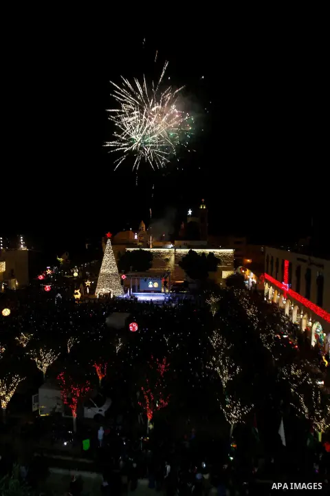 Palestinian Christians watch fireworks marking the lighting of a Christmas tree on December 3, 2016 at the Manger Square near the Church of the Nativity, revered as the site of Jesus Christ's birth, in the biblical West...