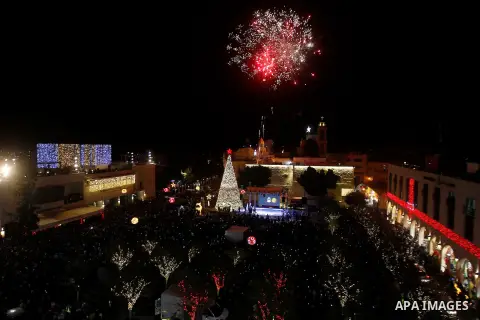 Palestinian Christians watch fireworks marking the lighting of a Christmas tree on December 3, 2016 at the Manger Square near the Church of the Nativity, revered as the site of Jesus Christ's birth, in the biblical West...