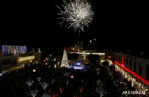 Palestinian Christians watch fireworks marking the lighting of a Christmas tree on December 3, 2016 at the Manger Square near the Church of the Nativity, revered as the site of Jesus Christ's birth, in the biblical West...