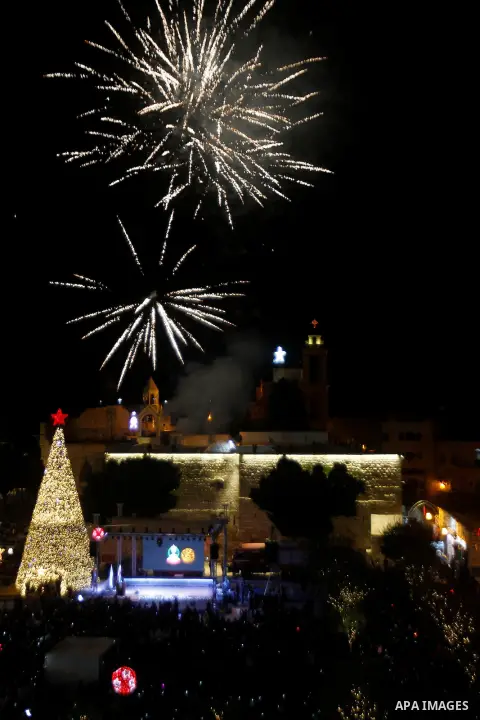 Palestinian Christians watch fireworks marking the lighting of a Christmas tree on December 3, 2016 at the Manger Square near the Church of the Nativity, revered as the site of Jesus Christ's birth, in the biblical West...