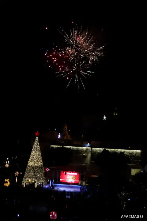 Palestinian Christians watch fireworks marking the lighting of a Christmas tree on December 3, 2016 at the Manger Square near the Church of the Nativity, revered as the site of Jesus Christ's birth, in the biblical West...