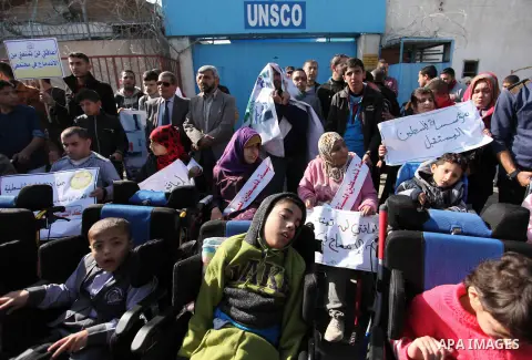 Palestinian girls with disabilities hold banners as they take parts in a rally in Gaza City demanding for the rights of people with disabilities in Gaza on December 5, 2016 Tens of thousands of Gazans are learning to liv...