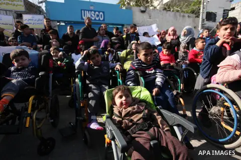 Palestinian girls with disabilities hold banners as they take parts in a rally in Gaza City demanding for the rights of people with disabilities in Gaza on December 5, 2016 Tens of thousands of Gazans are learning to liv...