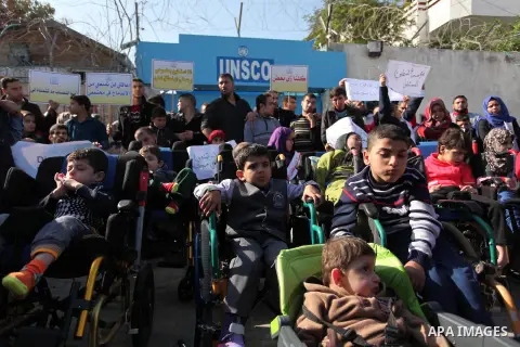 Palestinian girls with disabilities hold banners as they take parts in a rally in Gaza City demanding for the rights of people with disabilities in Gaza on December 5, 2016 Tens of thousands of Gazans are learning to liv...
