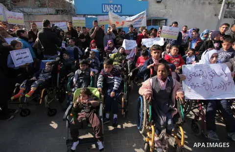 Palestinian girls with disabilities hold banners as they take parts in a rally in Gaza City demanding for the rights of people with disabilities in Gaza on December 5, 2016 Tens of thousands of Gazans are learning to liv...