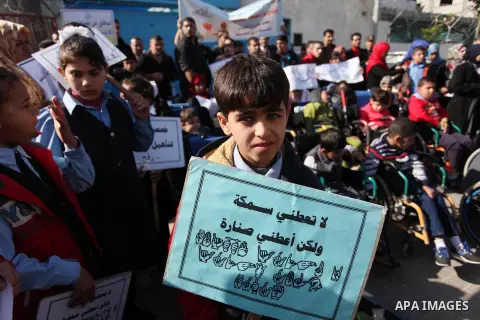 Palestinian girls with disabilities hold banners as they take parts in a rally in Gaza City demanding for the rights of people with disabilities in Gaza on December 5, 2016 Tens of thousands of Gazans are learning to liv...
