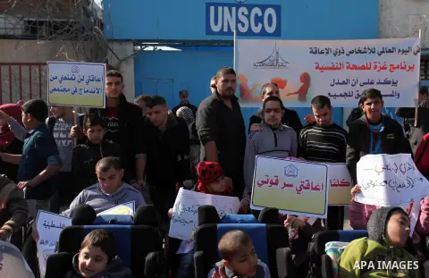Palestinian girls with disabilities hold banners as they take parts in a rally in Gaza City demanding for the rights of people with disabilities in Gaza on December 5, 2016 Tens of thousands of Gazans are learning to liv...