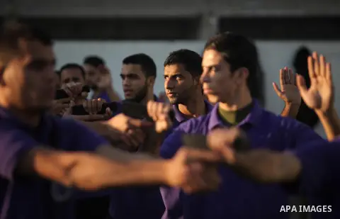 Palestinian applicants for a private security guard job at Castle Security company undergo a physical examination in an open-air playground in Gaza City on December 08, 2016. Photo by Ashraf Amra