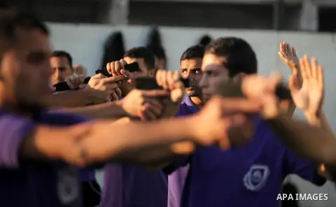 Palestinian applicants for a private security guard job at Castle Security company undergo a physical examination in an open-air playground in Gaza City on December 08, 2016. Photo by Ashraf Amra
