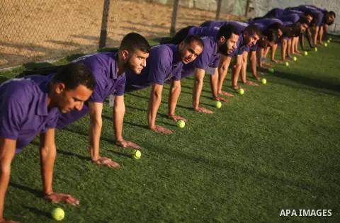 Palestinian applicants for a private security guard job at Castle Security company undergo a physical examination in an open-air playground in Gaza City on December 08, 2016. Photo by Ashraf Amra