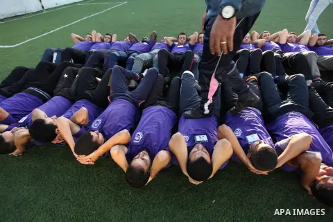 Palestinian applicants for a private security guard job at Castle Security company undergo a physical examination in an open-air playground in Gaza City on December 08, 2016. Photo by Ashraf Amra