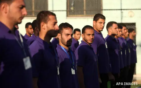 Palestinian applicants for a private security guard job at Castle Security company undergo a physical examination in an open-air playground in Gaza City on December 08, 2016. Photo by Ashraf Amra