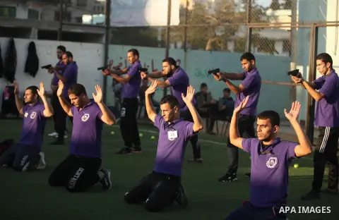 Palestinian applicants for a private security guard job at Castle Security company undergo a physical examination in an open-air playground in Gaza City on December 08, 2016. Photo by Ashraf Amra