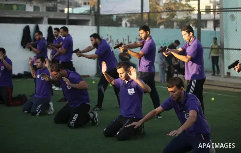 Palestinian applicants for a private security guard job at Castle Security company undergo a physical examination in an open-air playground in Gaza City on December 08, 2016. Photo by Ashraf Amra