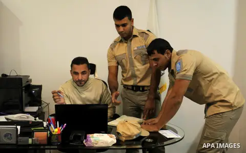 Palestinian Akram Al-Balawi, director of Castle Security company, speaks with a private security guard in the company's office in Gaza City on December 08, 2016. Photo by Ashraf Amra