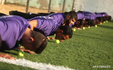 Palestinian applicants for a private security guard job at Castle Security company undergo a physical examination in an open-air playground in Gaza City on December 08, 2016. Photo by Ashraf Amra