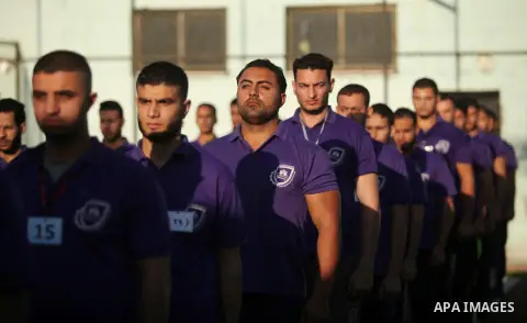 Palestinian applicants for a private security guard job at Castle Security company undergo a physical examination in an open-air playground in Gaza City on December 08, 2016. Photo by Ashraf Amra