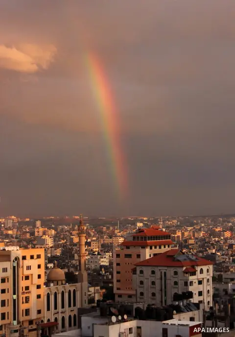 A rainbow appears over Gaza city after rain during the sunset on December 08, 2016. Photo by Stranger