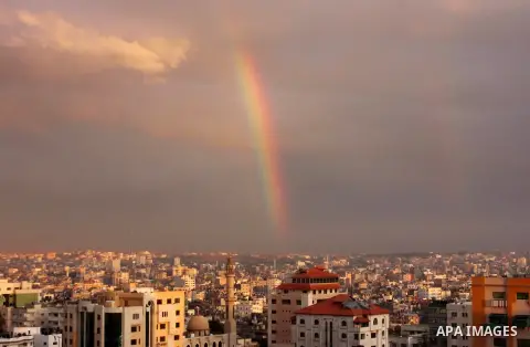 A rainbow appears over Gaza city after rain during the sunset on December 08, 2016. Photo by Stranger