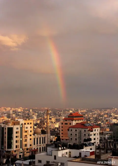A rainbow appears over Gaza city after rain during the sunset on December 08, 2016. Photo by Stranger