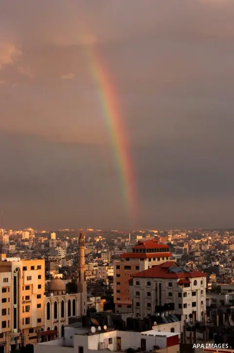 A rainbow appears over Gaza city after rain during the sunset on December 08, 2016. Photo by Stranger