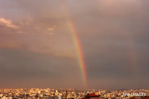A rainbow appears over Gaza city after rain during the sunset on December 08, 2016. Photo by Stranger