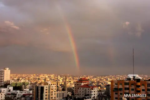 A rainbow appears over Gaza city after rain during the sunset on December 08, 2016. Photo by Stranger