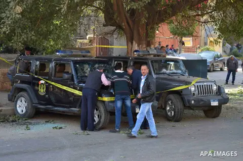 Egyptian security officials and investigators inspect the scene of a bomb blast in Giza Al Haram Street on the outskirts of Cairo, Egypt December 9, 2016. Photo by Amr Sayed