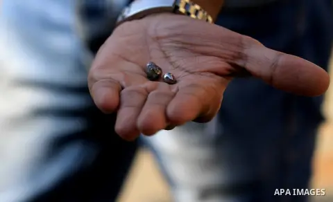 An Egyptian man shows small pieces of metal outside the Saint Peter and Saint Paul Coptic Orthodox Church after it was targeted by a bomb explosion on December 11, 2016, in Cairo's Abbasiya neighbourhood. The blast kille...