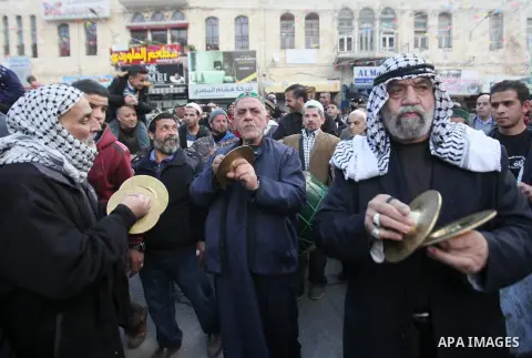 Palestinians Muslim Sufis play musical instruments as they parade through the streets during a ceremony commemorating the birth of Prophet Mohammed, known in Arabic as "Mawlid al-Nabawi", in the West Bank city of Nablus...