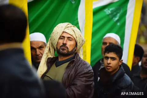 Egyptian Sufi Muslims chant prayers while walking in a march with banners as they celebrate "Mawlid al-Nabawi" or the birth of Prophet Mohammad, in old Cairo, Egypt, on December 11, 2016. Photo by Amr Sayed