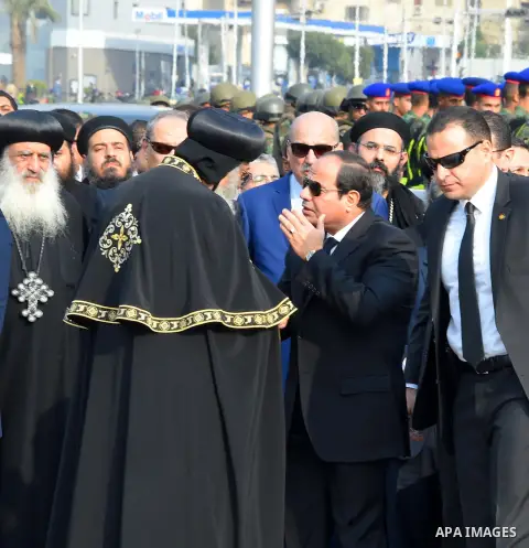 Egyptian President Abdel Fattah al-Sisi offers his condolences to Egypt's Coptic Pope Tawadros II in the end of the funeral of the victims of a bomb explosion that targeted a Coptic Orthodox Church in Cairo on December 1...