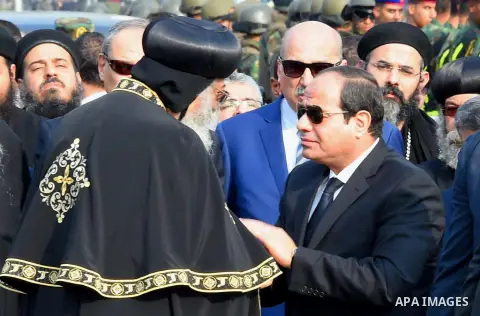 Egyptian President Abdel Fattah al-Sisi offers his condolences to Egypt's Coptic Pope Tawadros II in the end of the funeral of the victims of a bomb explosion that targeted a Coptic Orthodox Church in Cairo on December 1...