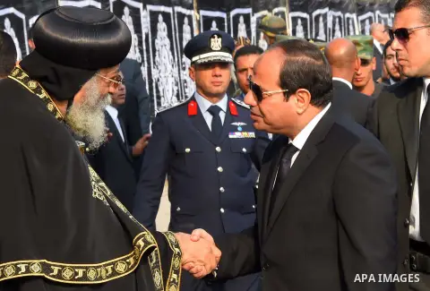 Egyptian President Abdel Fattah al-Sisi offers his condolences to Egypt's Coptic Pope Tawadros II in the end of the funeral of the victims of a bomb explosion that targeted a Coptic Orthodox Church in Cairo on December 1...