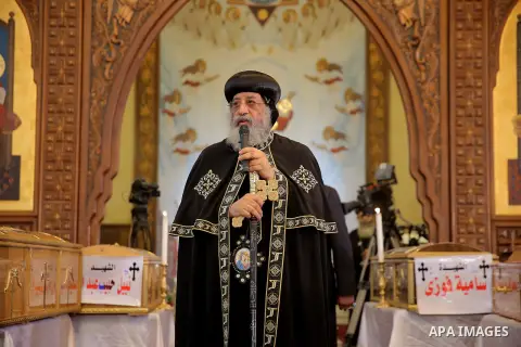 Egypt's Coptic Pope Tawadros II leads the funeral of the victims of a bomb explosion that targeted a Coptic Orthodox Church the previous day in Cairo, during their funeral in the Egyptian capital's Nassr City neighbourho...