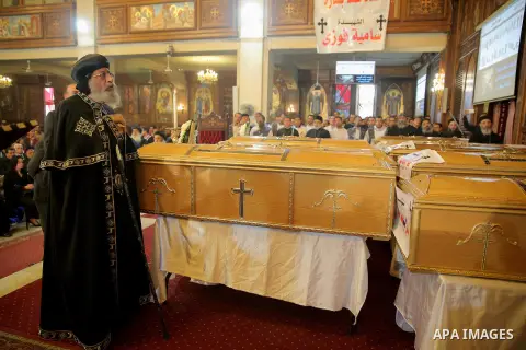 Egypt's Coptic Pope Tawadros II leads the funeral of the victims of a bomb explosion that targeted a Coptic Orthodox Church the previous day in Cairo, during their funeral in the Egyptian capital's Nassr City neighbourho...