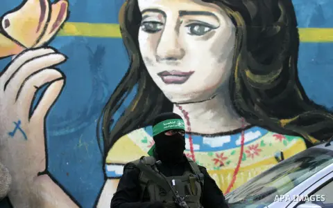 Members of the Ezzedine al-Qassam Brigades, the military wing of the Palestinian Islamist movement Hamas, take part in a rally marking the 29th anniversary of the founding of the Hamas movement, in Rafah in the southern...