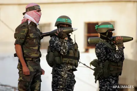 Members of the Ezzedine al-Qassam Brigades, the military wing of the Palestinian Islamist movement Hamas, take part in a rally marking the 29th anniversary of the founding of the Hamas movement, in Rafah in the southern...