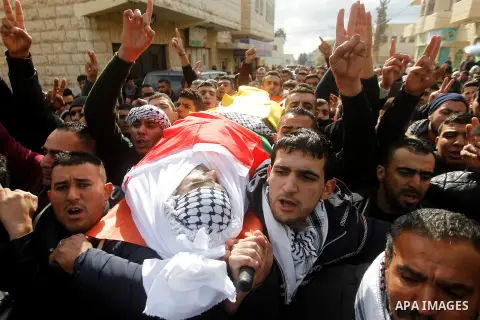 Mourners carry the body of Palestinian Firas Khdoor, who according to the Israeli military was shot dead after he carried out a car ramming attack last September, during his funeral after Israel released his body, in the...