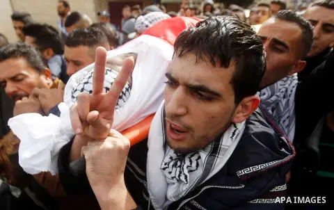 Mourners carry the body of Palestinian Firas Khdoor, who according to the Israeli military was shot dead after he carried out a car ramming attack last September, during his funeral after Israel released his body, in the...