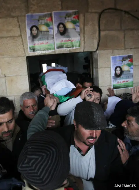 Mourners carry the body of Palestinian Rahiq Birawi, who according to the Israeli police was shot dead after she had advanced towards them with a knife in her hand at a checkpoint last October, during her funeral after I...