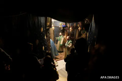 Christian worshippers pray inside the Grotto at the Church of the Nativity, believed to be the birthplace of Jesus Christ, in the West Bank city of Bethlehem, on December 18, 2016. Photo by Wisam Hashlamoun