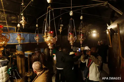 Christian worshippers visit a 14-pointed silver star at the Grotto in the Church of the Nativity, believed the birthplace of Jesus Christ, in the West Bank city of Bethlehem, on December 18, 2016. Photo by Wisam Hashlamo...