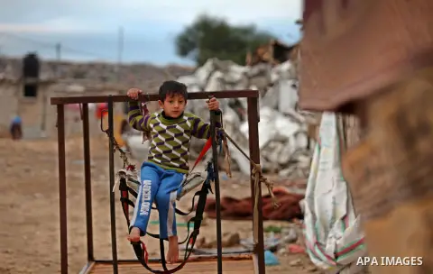 A Palestinian child stand outside his dwelling covered with plastic sheet in Khan Younis in the southern Gaza Strip December 19, 2016. Photo by Ashraf Amra